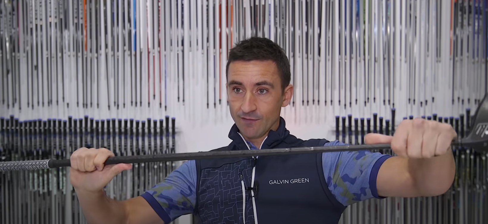 Club Champion Golfer Holding a Steadfast Driver Shaft In Front of Him