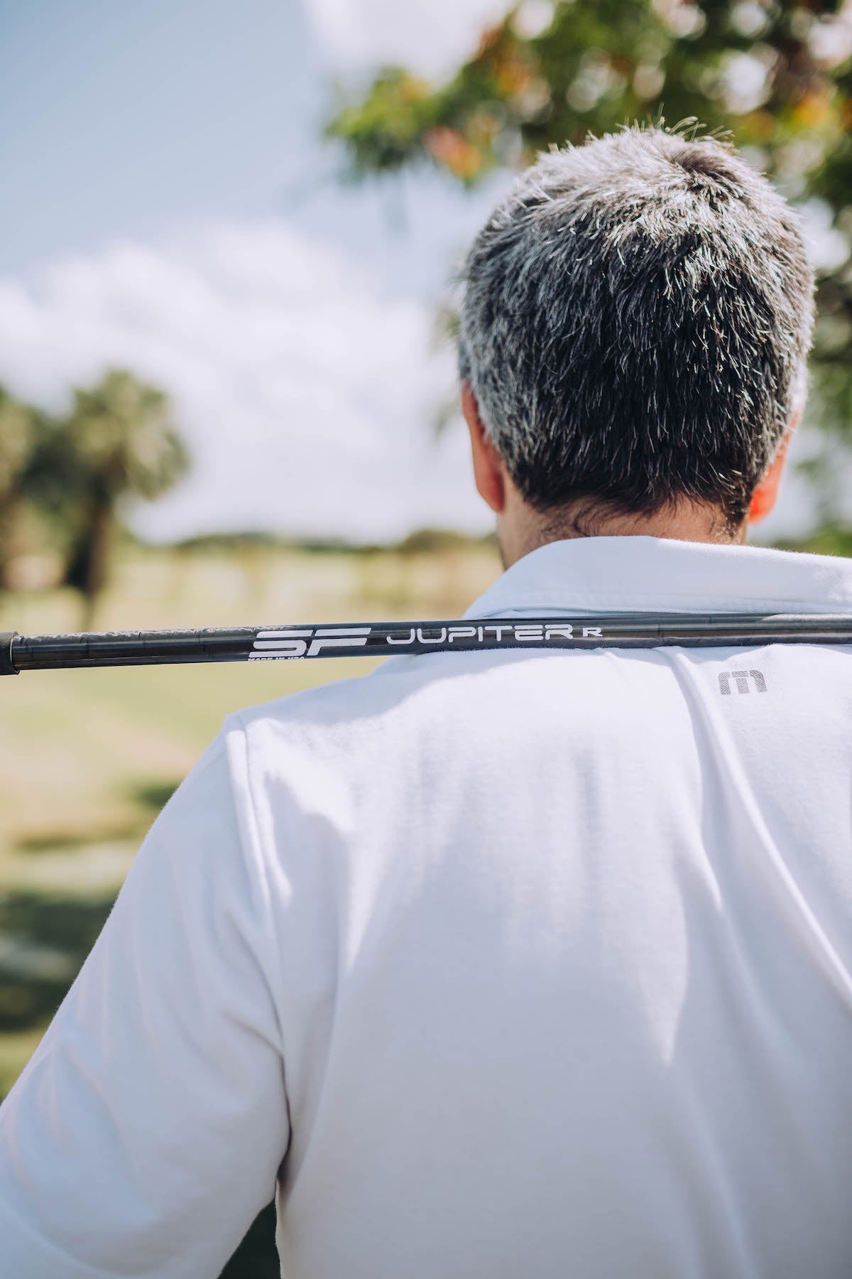 PGA Tour Golfer Holding a Jupiter One Driver Shaft on His Back