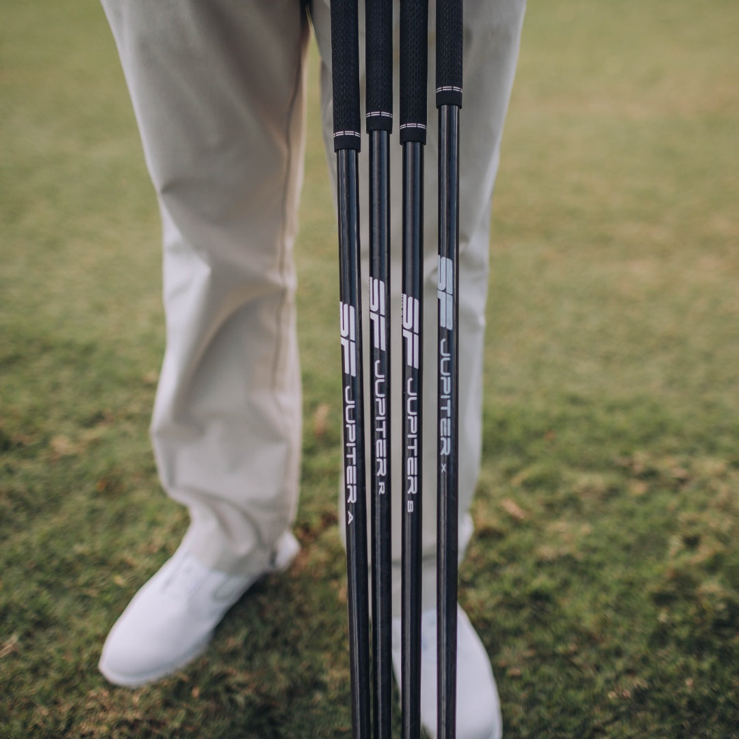 Golfer Standing Behind 4 Golf Clubs Fitted with Steadfast Carbon Fiber Golf Shafts