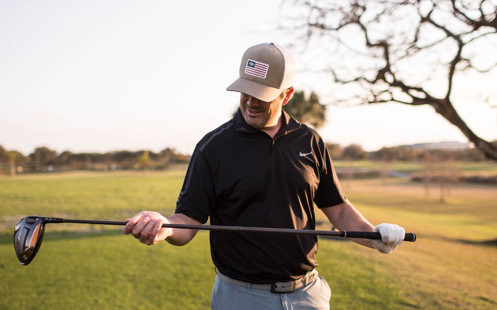 Golfer Smiling as He Holds His Driver and Looks at His Steadfast Driver Shaft